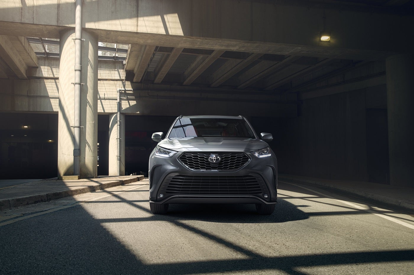 Toyota SUV parked inside a parking garage with the sun shining through