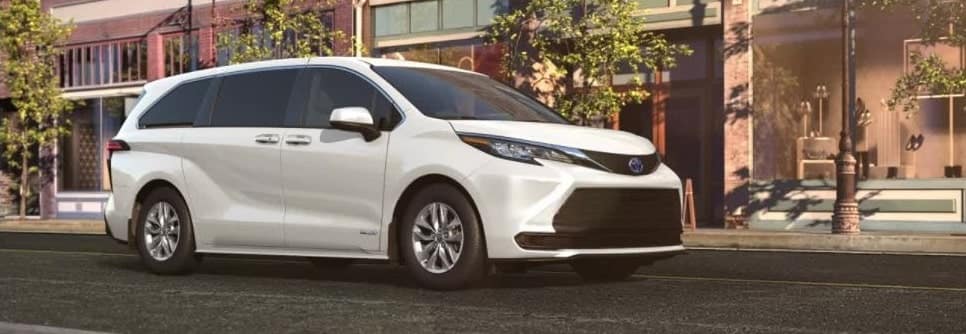 Toyota minivan parked on the road in front of a building